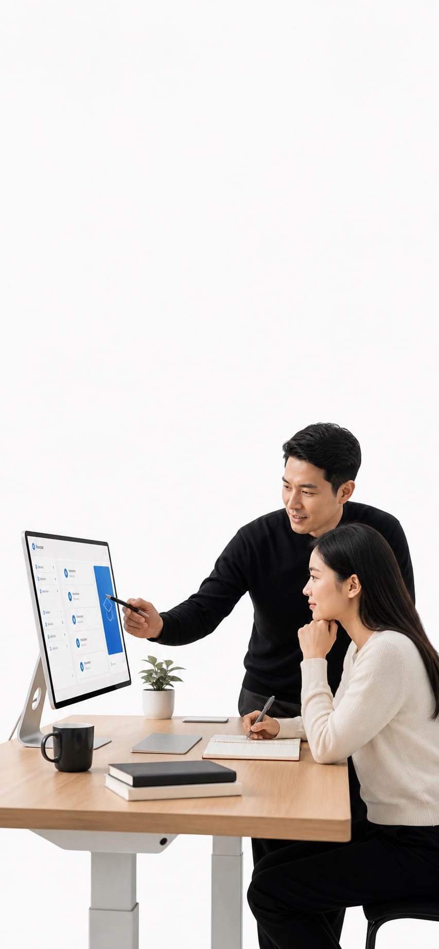 Mentor guiding a learner at a refined study desk in a bright white studio.